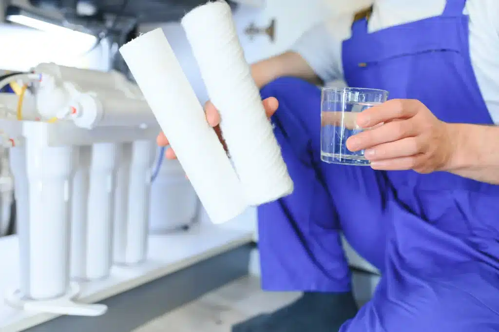 plumber installing a reverse osmosis water filtration system